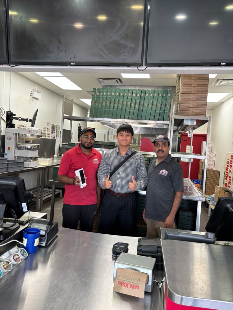Another GT Payments rep with the Papa John’s team behind the counter, after installing their new Clover terminal